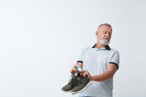 Man putting capsule shoe freshener in footwear on white background. Space for text - Photo, Image