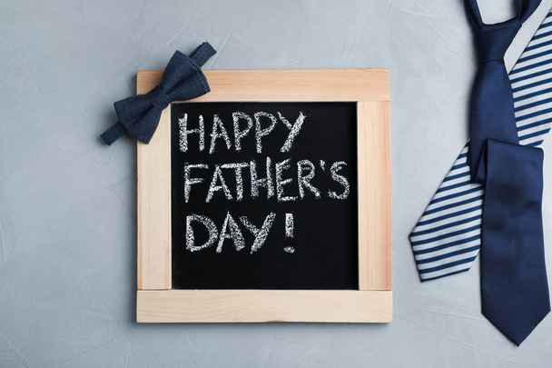 Flat lay composition with blackboard and ties on gray background. Happy Father's Day - Фото, зображення