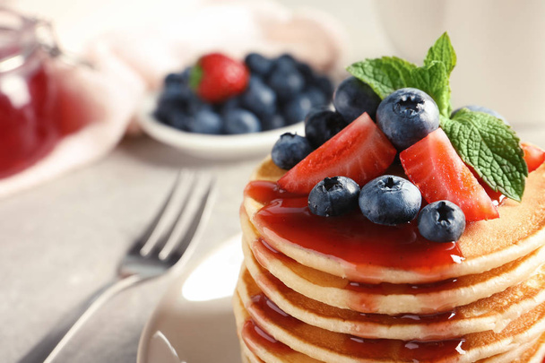 Plate with pancakes and berries on table, closeup - Foto, imagen