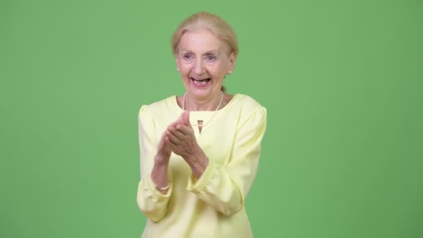 Happy senior businesswoman clapping hands - Footage, Video