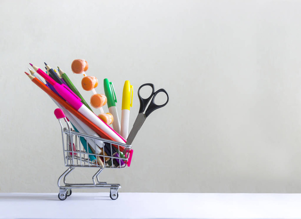 on a white background in a cart multi-colored stationery accessories study  - Φωτογραφία, εικόνα