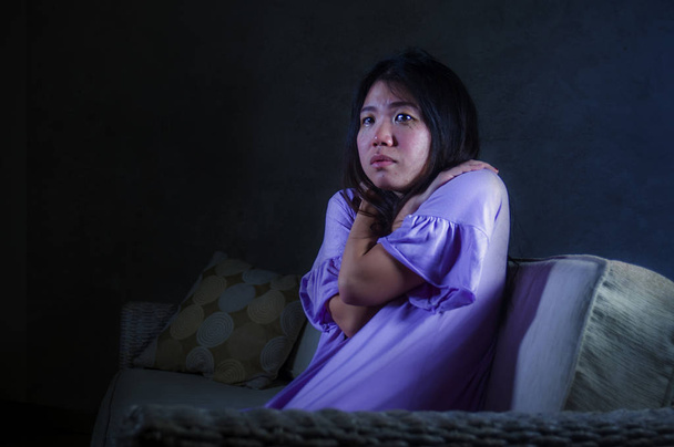 young sad and depressed Asian Japanese woman at home sofa couch crying desperate and helpless suffering anxiety and depression feeling pain in relationship and lonely life problem concept - Foto, Bild