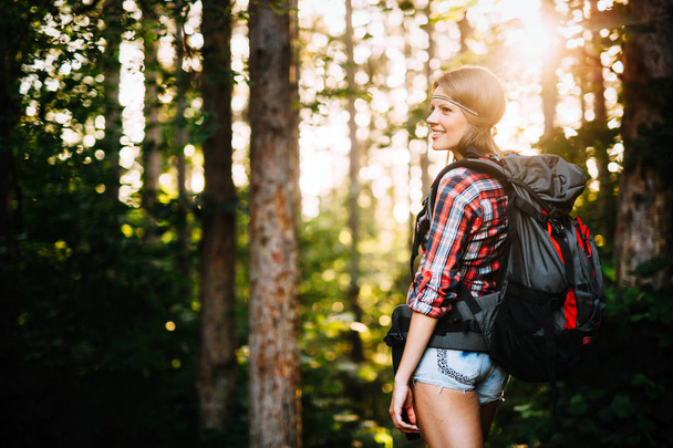 Portrait of pretty backpacker woman hiking in forest - Fotoğraf, Görsel