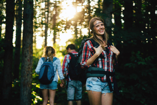 friends hiking in forest - Фото, зображення