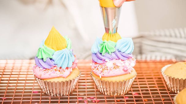 Paso a paso. Decoración de cupcakes de vainilla con temática unicornio con glaseado de crema de mantequilla de arco iris
. - Foto, Imagen