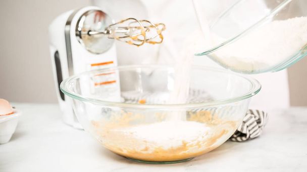 Step by step. Mixing ingredients for vanilla cupcakes. - Zdjęcie, obraz