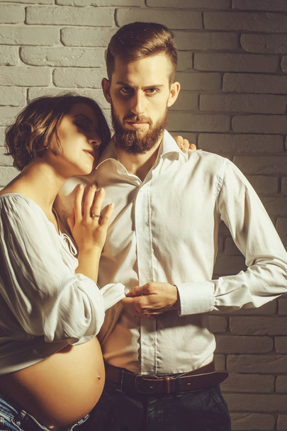 bearded man and pretty pregnant woman with round belly - Fotografie, Obrázek