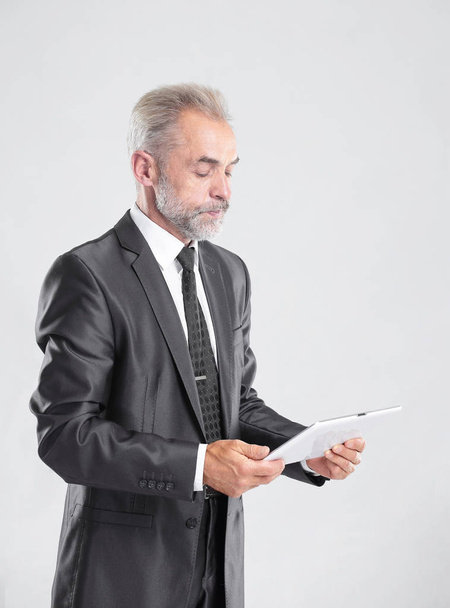 modern businessman reading text on a digital tablet.isolated on grey background - Photo, Image