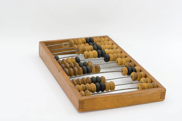 Old brown wooden abacus on a bright white background. - Foto, afbeelding