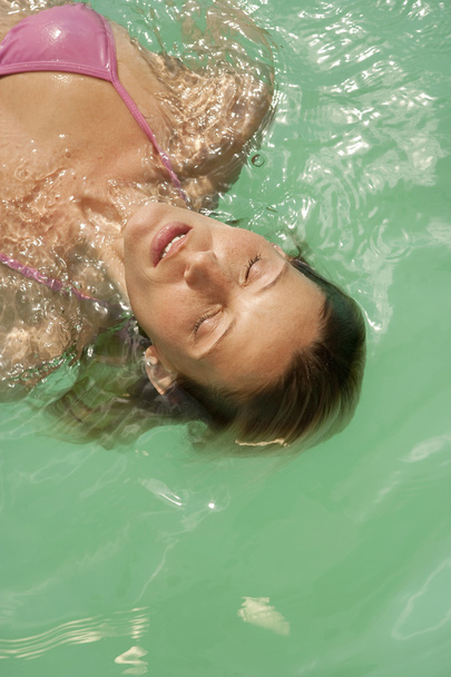woman swimming in turquoise waters. - Photo, Image