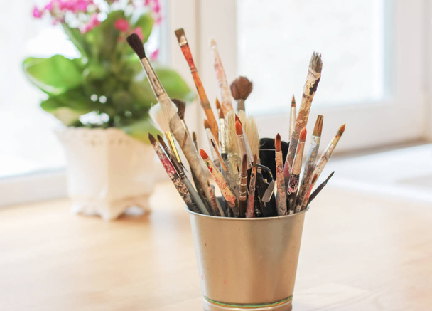 Different brushes of the artist in a metal bucket, selective focus - Photo, Image