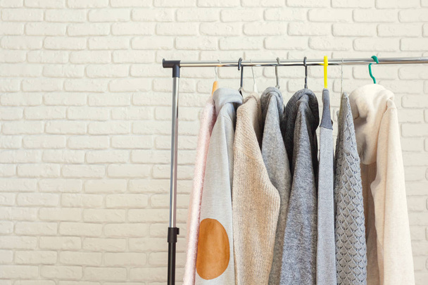 Clothing rack with hangers, close-up view  - Φωτογραφία, εικόνα