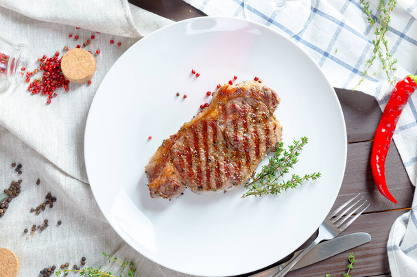 Grilled steak with spices on white plate - Photo, Image
