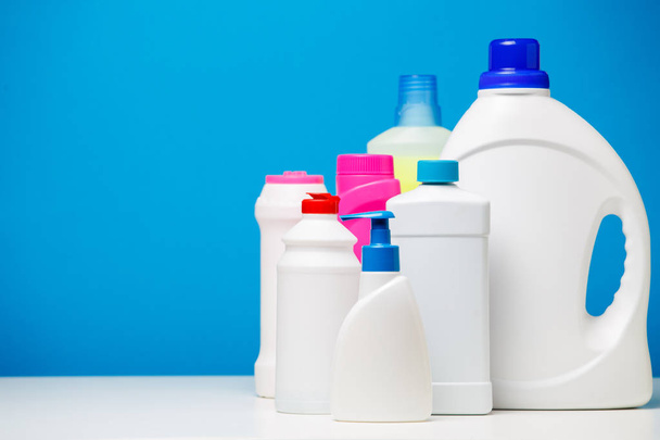Photo bottles of cleaning products isolated on blue background, - Valokuva, kuva