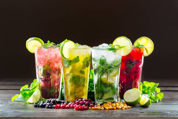 Different types of mojito cocktail on dark brown background - Foto, Imagen