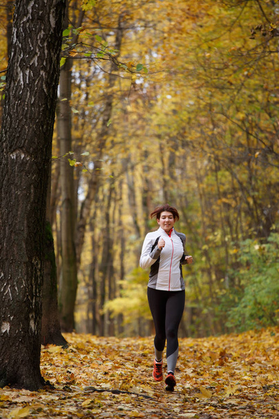 Image of sports brunette on morning run in autumn - Valokuva, kuva