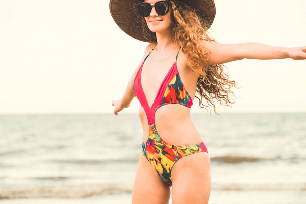 Tatil seyahat etmek tatil için yaz aylarında tropikal plaj keyfi yerinde mayo giyen mutlu genç kadın. - Fotoğraf, Görsel