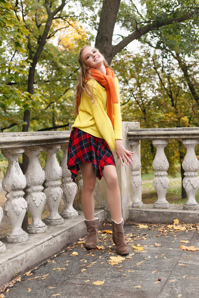 season and people concept - beautiful happy young woman having fun with leaves in autumn park - Photo, image