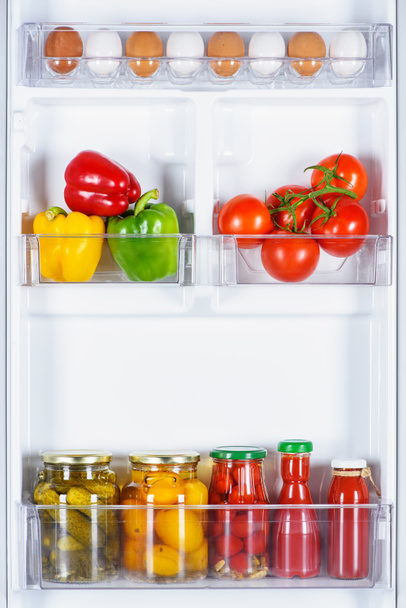 tasty ripe and preserved vegetables in fridge - Foto, afbeelding