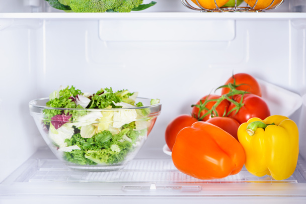 bowl of salad and ripe bell peppers in fridge - Photo, Image