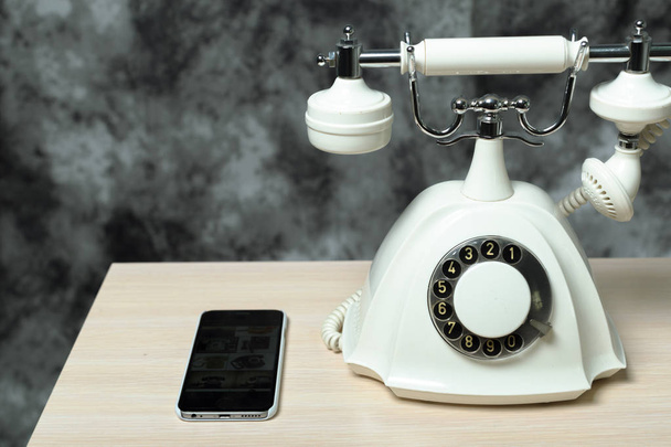 high angle view of white Retro telephone and smartphone on table - Foto, Imagem
