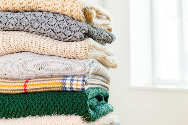 Stack of white cozy knitted sweaters , close-up  - Φωτογραφία, εικόνα