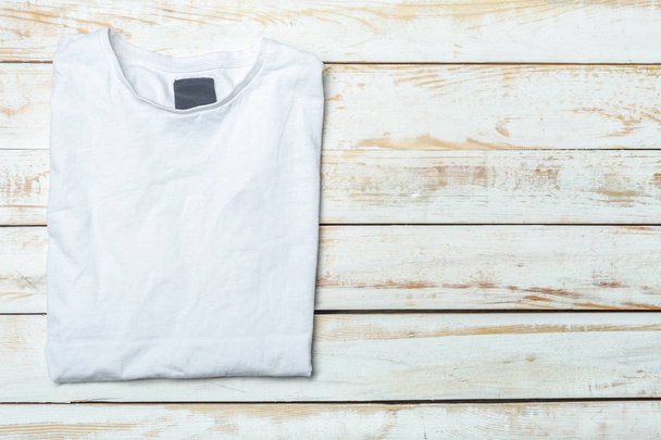 white t-shirt on rustic wood background - Foto, immagini