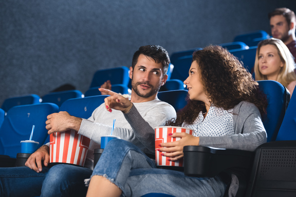 couple with popcorn watching movie together in cinema  - Фото, зображення