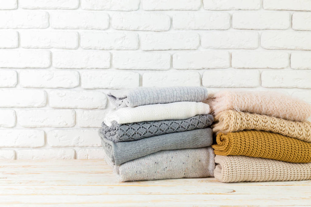 Stack of white cozy knitted sweaters  - Φωτογραφία, εικόνα