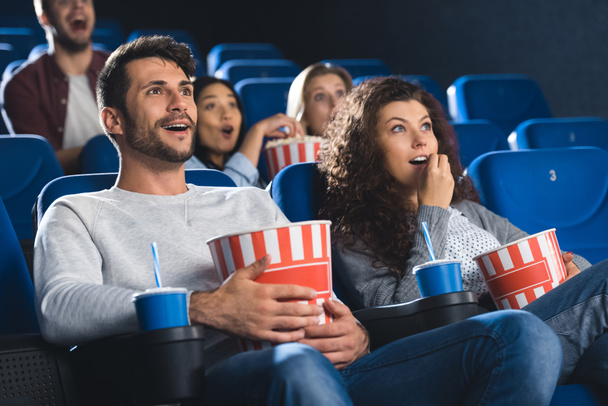 pareja emocional con palomitas de maíz viendo películas juntos en el cine
  - Foto, Imagen