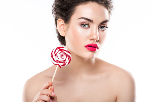 attractive stylish nude woman holding red lollipop, isolated on white - Fotó, kép