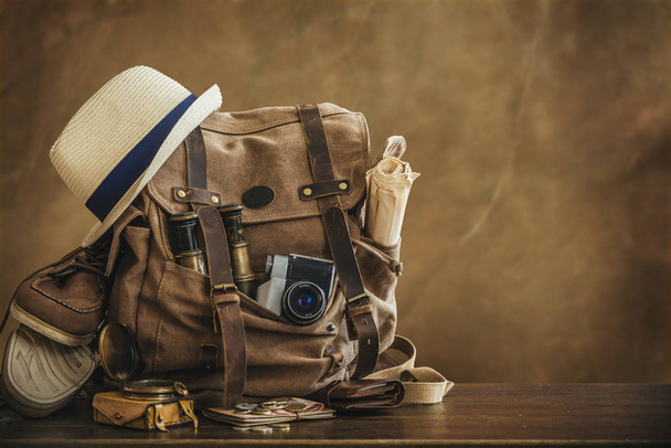 Looking image of travelling concept, essential vacation items. Backpack. Retro effect. - 写真・画像