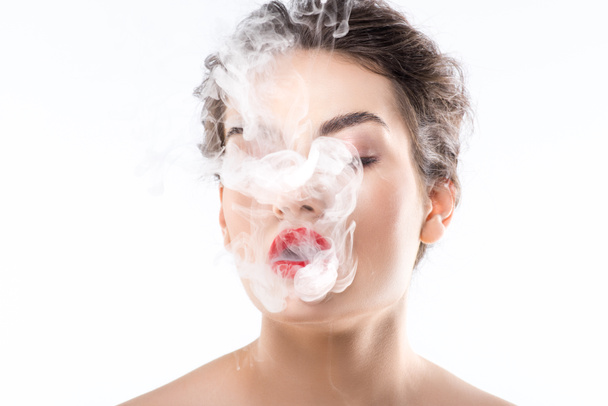 beautiful woman blowing smoke, isolated on white - Foto, Imagem