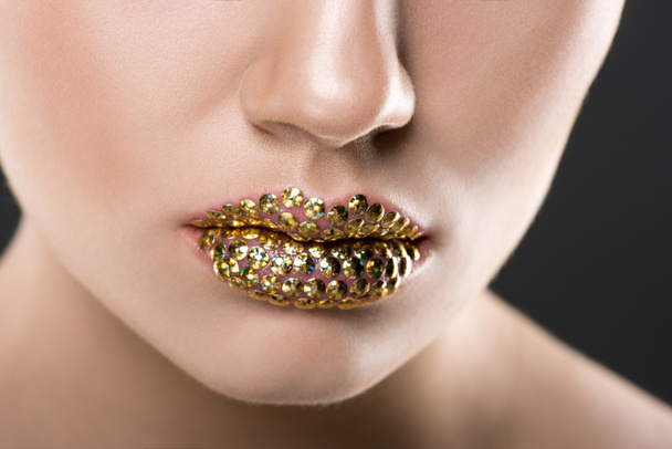 partial view of woman with golden lips, isolated on grey - Foto, Imagem