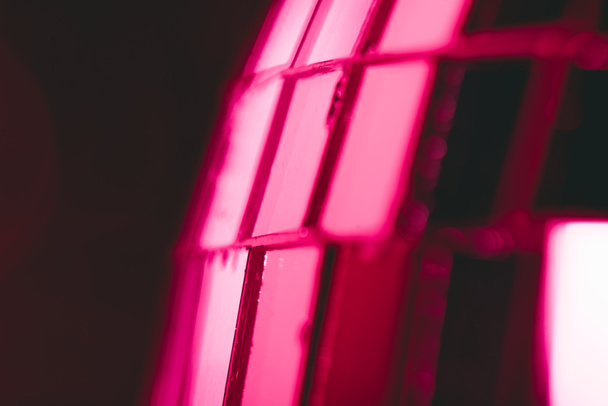 close-up view of shiny pink disco ball on black background - Fotó, kép