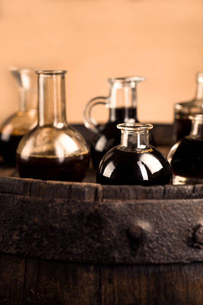 Old barrel and bottles for  balsamic vinegar in modena  - Photo, Image