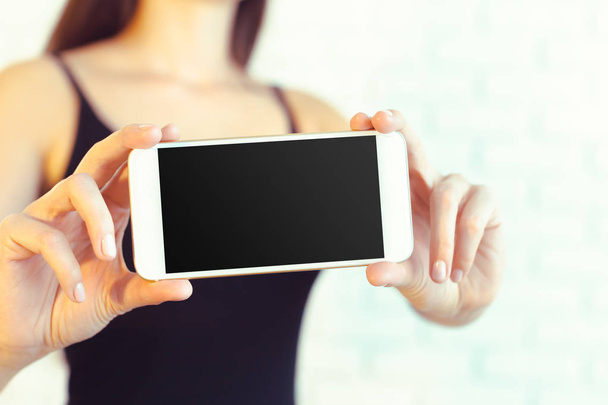 Woman with modern mobile phone in hands  - Photo, image