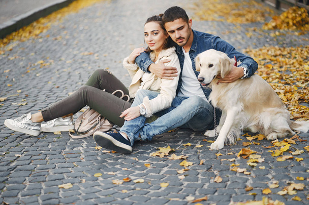couple walking their dog on a sunny autumn day - Foto, immagini
