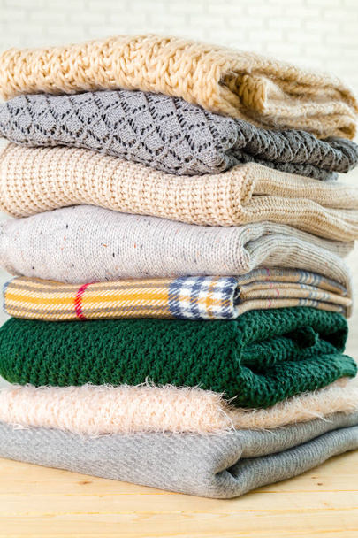 Stack of white cozy knitted sweaters  - Photo, image