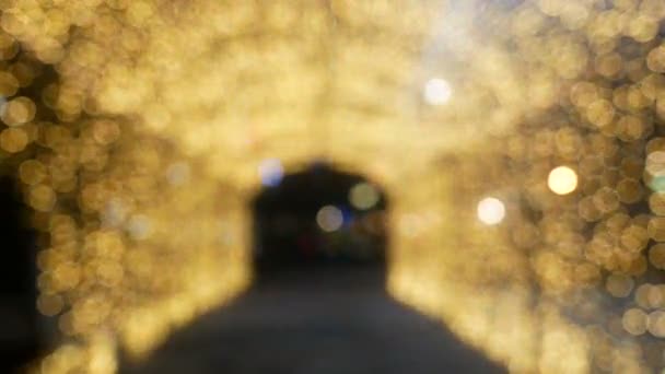 Tunnel aus verschwommenem gelb-goldenem Bokeh-Licht defokussiert Hintergrund und strukturiert für Weihnachten, Neujahr Urlaub Party und Feier Hintergrund  - Filmmaterial, Video