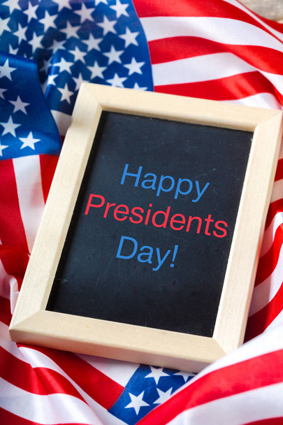 the text happy presidents day written in a chalkboard and a flag of the United States - Photo, Image