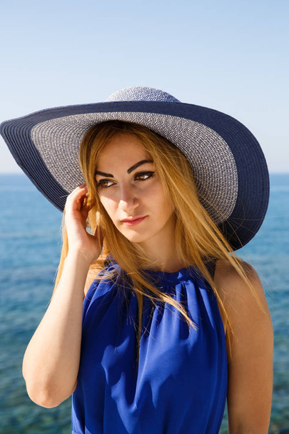 Pretty blond woman in the blue dress at the beach in Cyprus. - Fotoğraf, Görsel