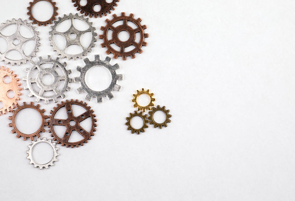 Different sizes and colored gears on a white background - 写真・画像