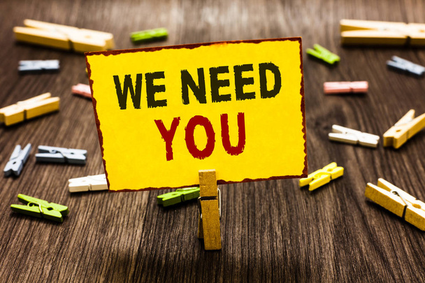 Handwriting text writing We Need You. Concept meaning Employee Help Need Workers Recruitment Headhunting Employment Clothespin holding yellow paper note several clothespins wooden floor. - Photo, Image