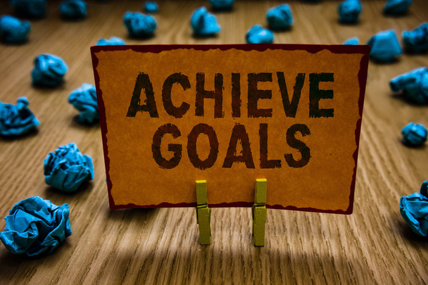 Conceptual hand writing showing Achieve Goals. Business photo text Results oriented Reach Target Effective Planning Succeed Clothespins holding orange paper note crumpled papers mistake. - Photo, Image