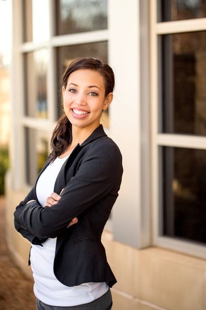 Business woman standing outside an office building. - Photo, image
