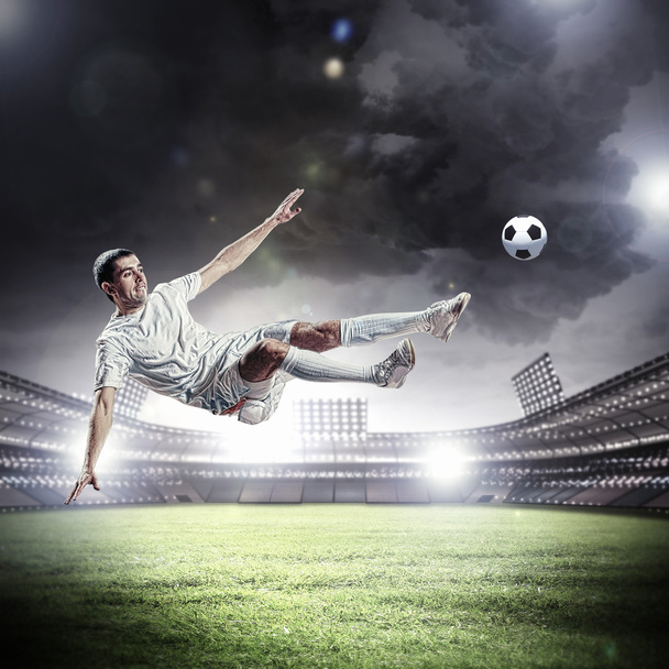 football player striking the ball - Foto, imagen