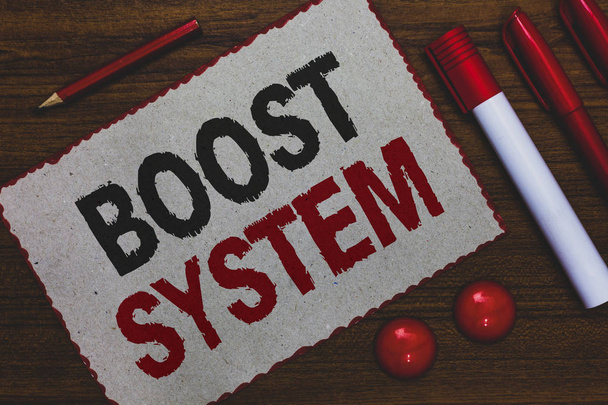 Conceptual hand writing showing Boost System. Business photo showcasing Rejuvenate Upgrade Strengthen Be Healthier Holistic approach White paper red borders markers pencils wooden background. - Foto, Bild