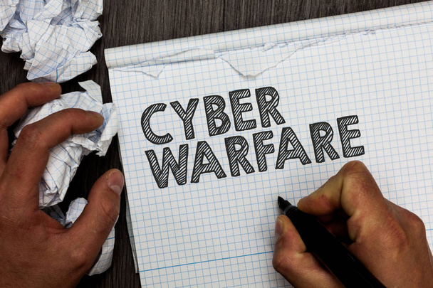 Word writing text Cyber Warfare. Business concept for Virtual War Hackers System Attacks Digital Thief Stalker Man holding marker notebook crumpled papers several tries mistakes made. - Photo, Image