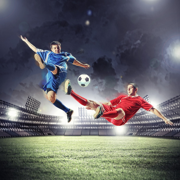 two football players striking the ball - Zdjęcie, obraz